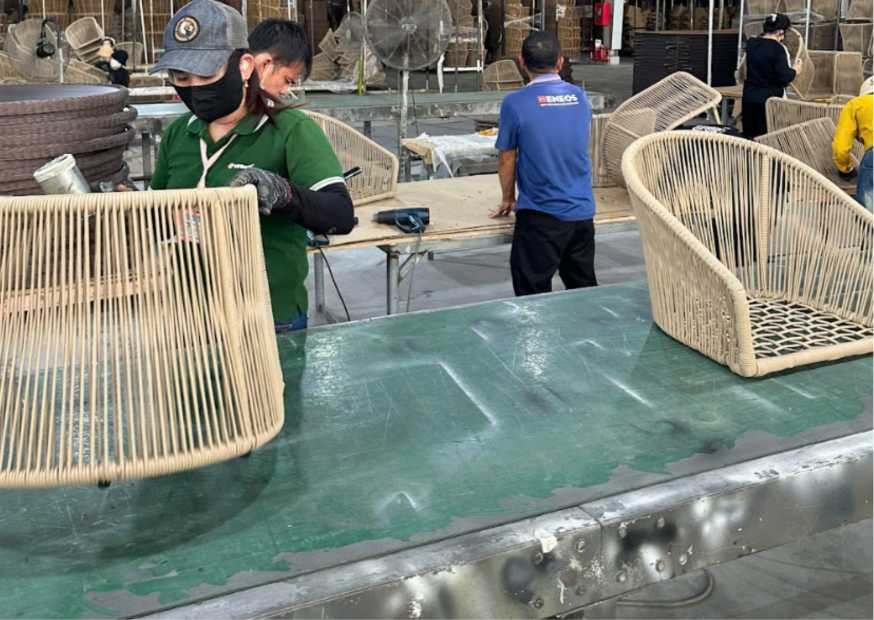 Hand weaving curved outdoor furniture frames in the Saigon Wicker factory